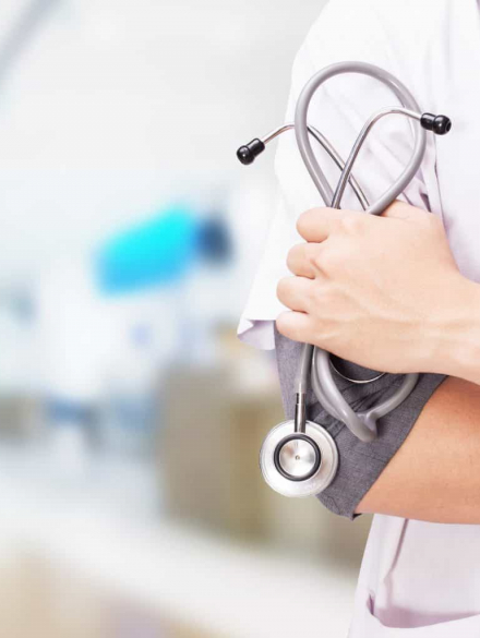 Healthcare professional holding a stethoscope, representing the healthcare vertical supported by Prospecta.